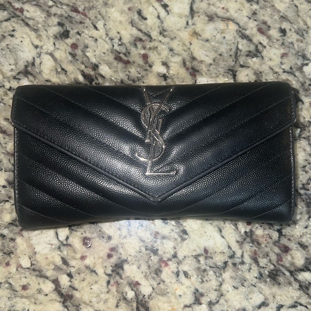 Black Yves Saint Laurent Monogram quilted wallet.